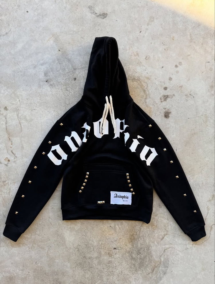 Diamant Noir Studded Hoodieggg featuring a bold design with studs and logo on a black background.